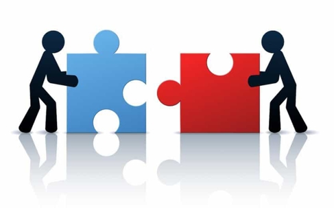 Two stick figures moving puzzle pieces